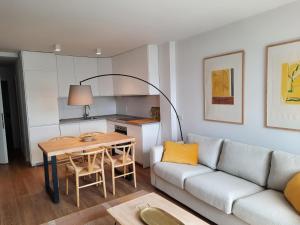 a living room with a couch and a table at Apartamentos Casa La Rambla in San Esteban de Pravia