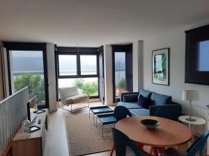 a living room with a couch and a table at Apartamentos Casa La Rambla in San Esteban de Pravia