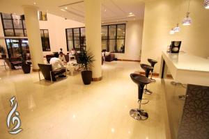 a lobby with people sitting at tables in a building at Rafa Homes in Riyadh +14 photos