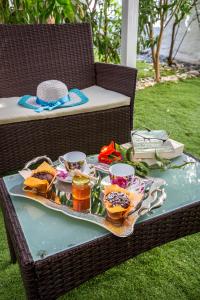 a table with a tray of food on a wicker chair at Ioanna's House in Potos