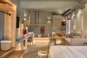 a kitchen and living room with a table and a couch at Avithos Resort Hotel in Svoronata