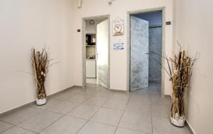 a hallway with two vases with plants in it at Ioanna's House in Potos