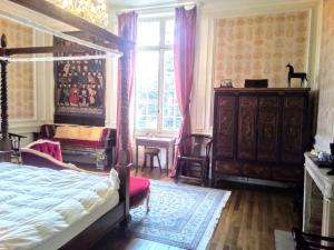 a bedroom with a bed and a dresser and a window at Chateau du Guérinet D'Orchaise in Orchaise