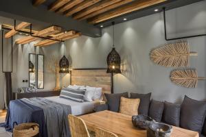 a room with a bed and a table and a couch at Avithos Resort Hotel in Svoronata