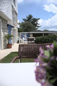 a patio with two benches and a table and flowers at Tepe Hotel in Alaçatı