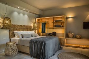 a bedroom with a bed and a table and chairs at Avithos Resort Hotel in Svoronata
