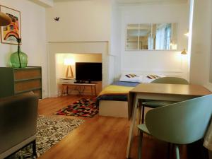 a bedroom with a bed and a table and a desk at Au COCON QUIMPEROIS in Quimper