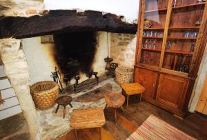 a living room with a stone fireplace in a house at Comenda da Povoa in Tomar