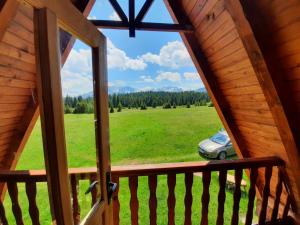 a view of a car from a window in a cabin at Holiday Home Jabucilo in Žabljak +18 photos