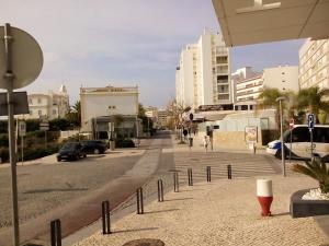 a city street with cars parked on the road at Charming apartment in Portimão – 45 m² with a shared pool in Portimão