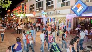 a crowd of people walking down a street at night at Charming apartment in Portimão – 45 m² with a shared pool in Portimão