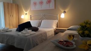 a bed with towels and a bowl of fruit on it at Giardino dei Baroni house in Marina di Mancaversa +162 photos