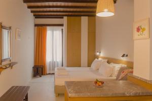 A bed or beds in a room at Kalypso Studios & Rooms