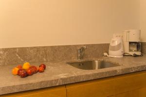 A kitchen or kitchenette at Kalypso Studios & Rooms Még 37 kép