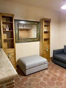 a room with a bed and a couch and shelves at Da Artù in Cittaducale