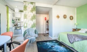 a bedroom with a bed and a table and chairs at Pinjakoti in Lahti +160 photos