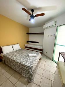 a bedroom with a bed and a ceiling fan at POUSADA KANADY in Itacaré