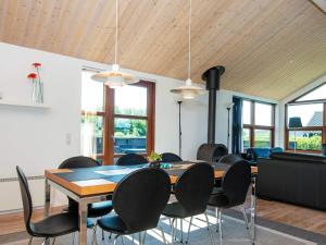 a dining room with a table and chairs at Four-Bedroom Holiday home in Hemmet 6 in Hemmet