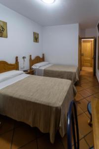 Ένα ή περισσότερα κρεβάτια σε δωμάτιο στο Hostal San Ramón