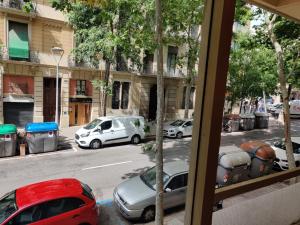 a view from a window of cars parked on a street at Guest House Barcelona Bruc in Barcelona