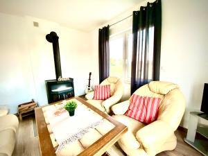 a living room with two chairs and a table at Dom Kaszubka Oaza in Sominy