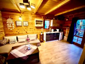 a living room with a couch and a table at Domek w sercu Kaszub in Sominy