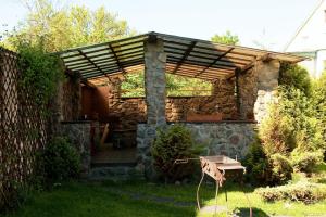 a stone building with a pergola in a yard at Cranz Hotel in Zelenogradsk
