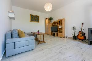 a living room with a blue couch and a table at House Tinac in Crikvenica