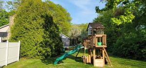 a playground with a slide in a yard at The Tallwood Motel in Wells