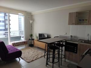 a kitchen with a table and chairs in a room at New Relax Departamento in La Serena