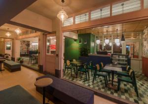 a restaurant with tables and chairs in a room at The Great Madras by Hotel Calmo in Singapore