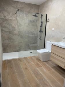 a bathroom with a shower and a toilet and a sink at UIM Mediterraneo CASA Plomo Wifi in Puerto de Sagunto +20 photos