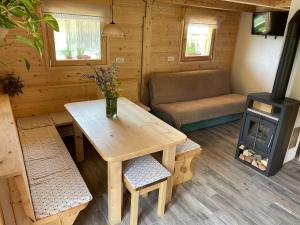 a living room with a table and a stove at Miha`s cottage in Bohinj