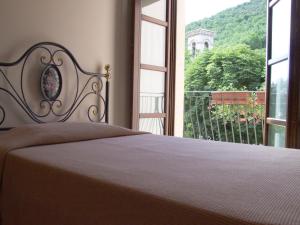 Posteľ alebo postele v izbe v ubytovaní Albergo La Casa Nel Bosco