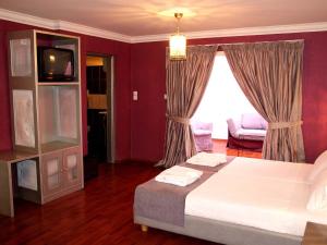 a bedroom with a bed and a tv in a room at Delphi Art Hotel by Prima Hotels in Athens
