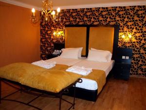 a bedroom with a bed with two towels on it at Delphi Art Hotel by Prima Hotels in Athens