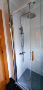 a shower with a glass door in a bathroom at Hotel La Cuesta in Tapia de Casariego +32 photos