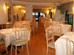 a dining room with white tables and chairs at Delphi Art Hotel by Prima Hotels in Athens