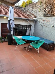 un patio con mesa, 2 sillas y sombrilla en Melvilla Studio, en Johannesburgo