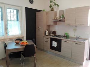 a kitchen with a table with a bowl of fruit on it at L'Angoletto#1 in Ciampino