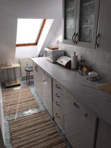 a kitchen with a counter top with a microwave at MIESZKANIE w Centrum PRZY PROMENADZIE i JEZIORZE Stare Miasto!!! Parking ! in Mrągowo