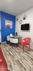 a living room with a table and a red chair at Huelintown in Málaga