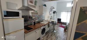 a kitchen with a washer and dryer in a room at Huelintown in Málaga