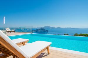 a villa with a pool and a view of the water at Villa Despina - Marathia View Private Luxury Villa in Marathias