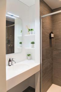 a bathroom with a sink and a shower at Salotto Brè - Bed & Breakfast charming rooms in Lugano