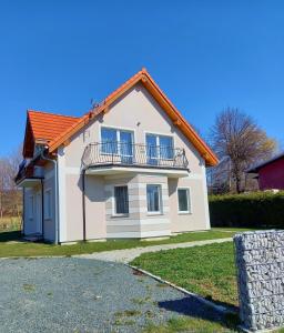 a white house with an orange roof at Apartamenty EverySky - Dom Źródlana 11 in Kowary