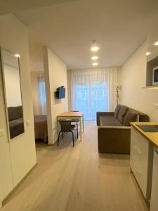 a living room with a couch and a table at Apartamentai '55' in Juodkrantė +4 photos
