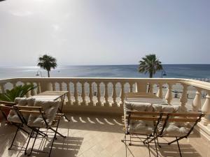 a balcony with chairs and a view of the ocean at Le Camere di Rosanna in Marina di Gioiosa Ionica