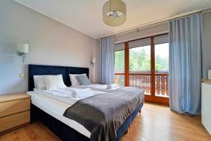 Posteľ alebo postele v izbe v ubytovaní Apartamenty EverySky - Skalna 32