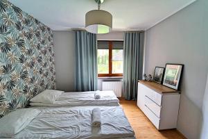 Posteľ alebo postele v izbe v ubytovaní Apartamenty EverySky - Skalna 32 + 2 fotografie